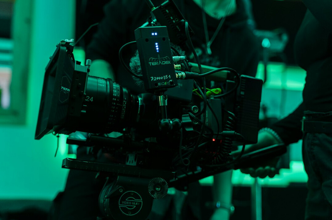 Modern TV broadcast control room with camera rigs and monitors
